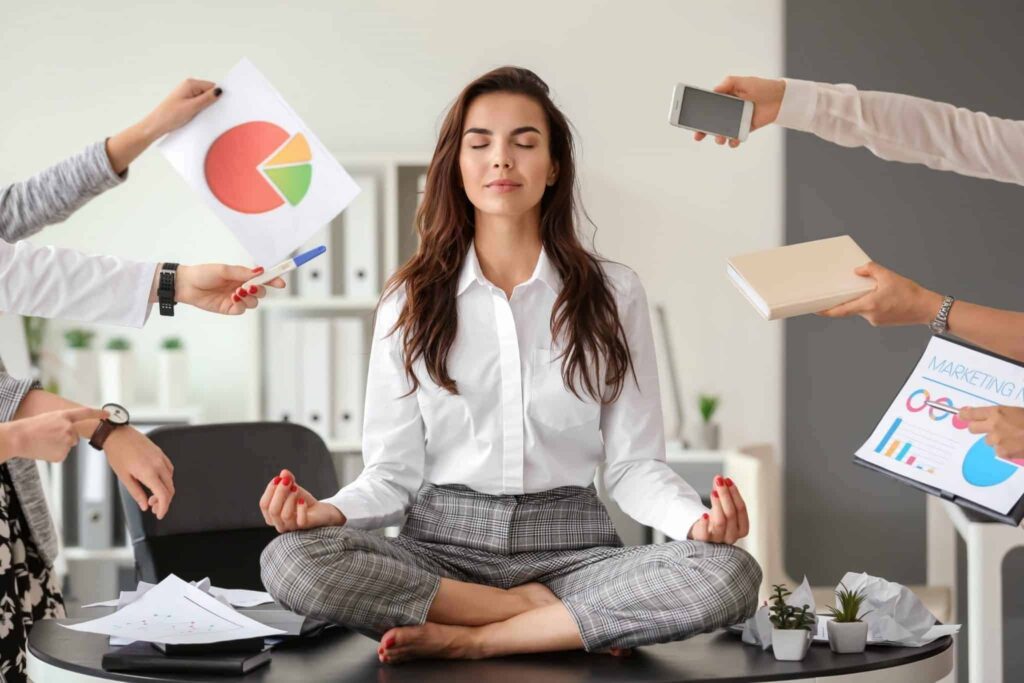 Business woman coping with stress around her through meditation