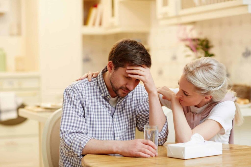 Woman tending to her depressed spouse