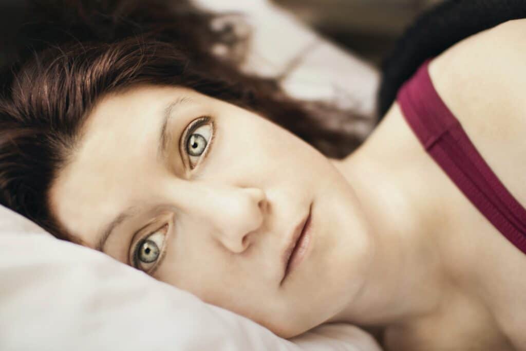 A woman is unable to sleep at night due to rumination