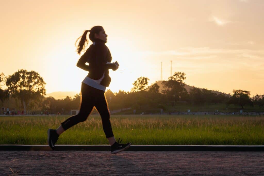 Woman running to improve her overall wellbeing